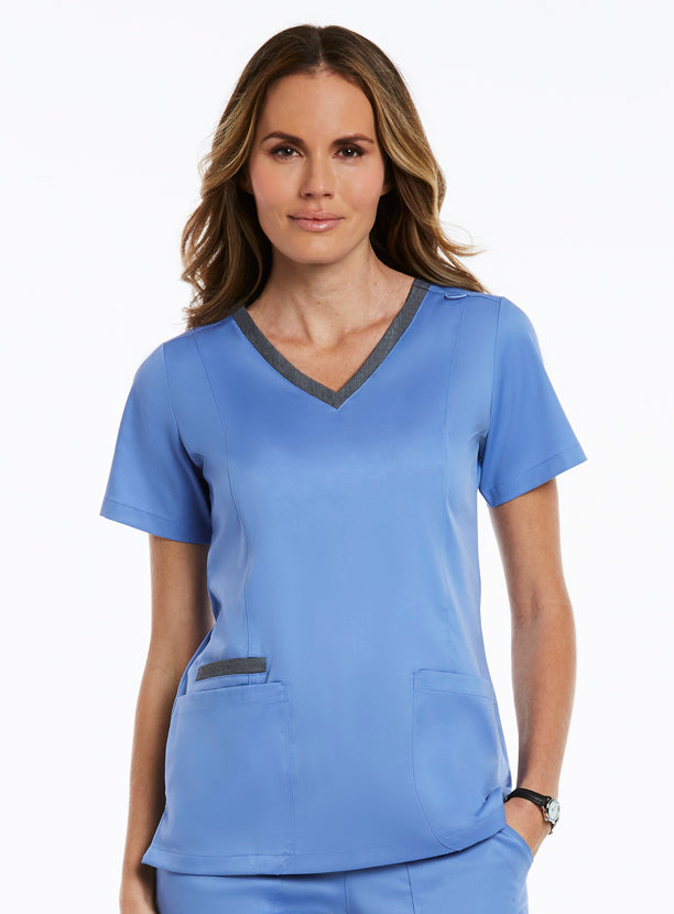 Woman in a 3502 Matrix - Contrast Double V-Neck Top and a watch, standing against a white background.