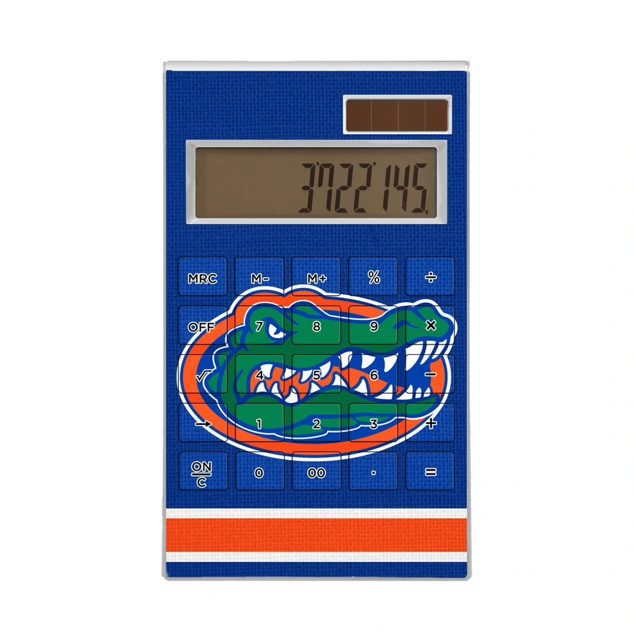 A FLORIDA GATORS STRIPE DESKTOP CALCULATOR with a blue number pad and an illustration of an alligator on it, displaying the number 7327.05 on its screen.