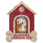 A golden retriever smiling in a wooden alabama crimson tide themed photo frame shaped like a doghouse.