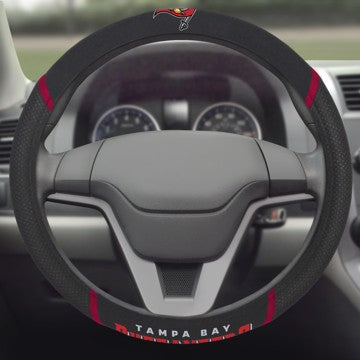 Sentence with product name: NFL - Tampa Bay Buccaneers Steering Wheel Cover, viewed from driver's seat perspective, with dashboard in the background.