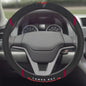 Sentence with product name: NFL - Tampa Bay Buccaneers Steering Wheel Cover, viewed from driver's seat perspective, with dashboard in the background.