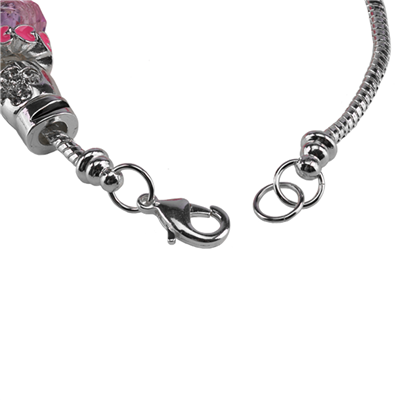 Close-up of a Pinktober Breast Cancer Charm Bracelet with a lobster clasp and detailed charms against a white background.