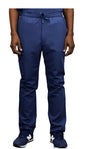 Front view of a person wearing WYND Men's Scrub Pants 830 with a drawstring and navy sneakers, cropped at the waist, visible from torso to feet.