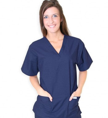 Woman in navy blue scrubs standing with hands on hips, smiling at the camera against a white background.
