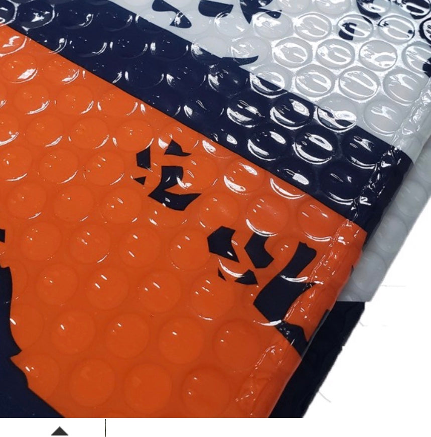 A stack of colorful Miami Hurricanes Auto Shades with bubble wrap interiors, featuring navy blue, white, and orange colors with a visible black logo on the navy shade.