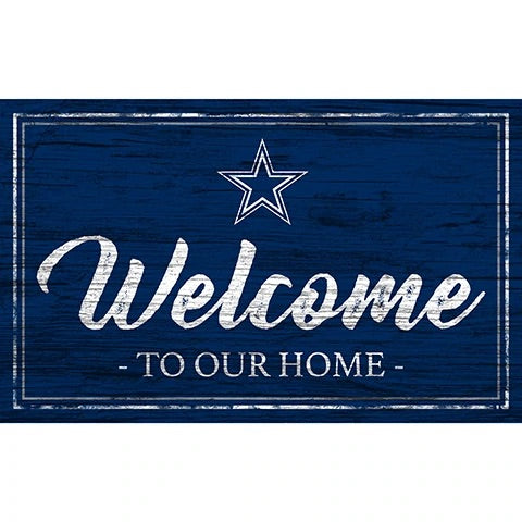 A rectangular sign featuring a dark blue wooden background and the word "welcome" in cursive white letters with "to our home" and a white star above.
