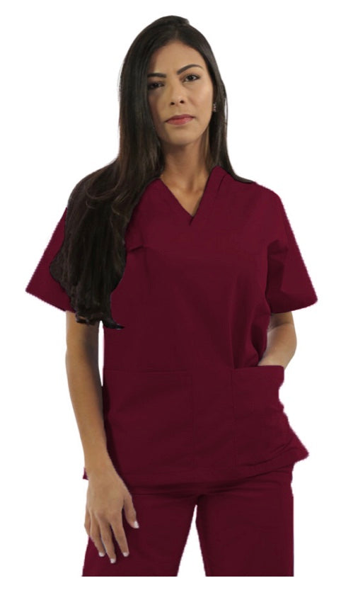 A woman with long dark hair wearing a maroon scrub suit, standing against a plain background.