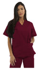 A woman with long dark hair wearing a maroon scrub suit, standing against a plain background.