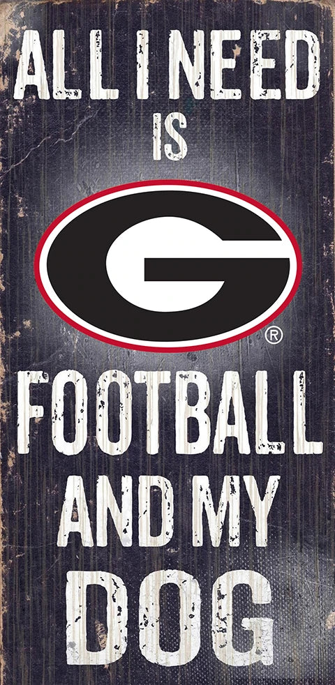 A sign with the text "all i need is football and my dog," featuring the logo of the green bay packers on a distressed wood background.