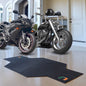 Two University of Miami Hurricanes Motorcycle Mats parked in a garage with protective mats on the floor.