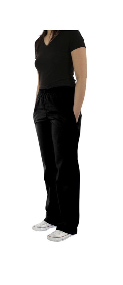 Woman standing in a relaxed pose, wearing a black v-neck t-shirt and UltraSoft Unisex Classic Elastic Waist Scrub Pants 300C with pockets, paired with white sneakers.