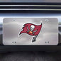 Sentence with product name: Tampa Bay Buccaneers Diecast License Plate, featuring a red pirate flag and a skull holding a football, mounted on a car's front grille.