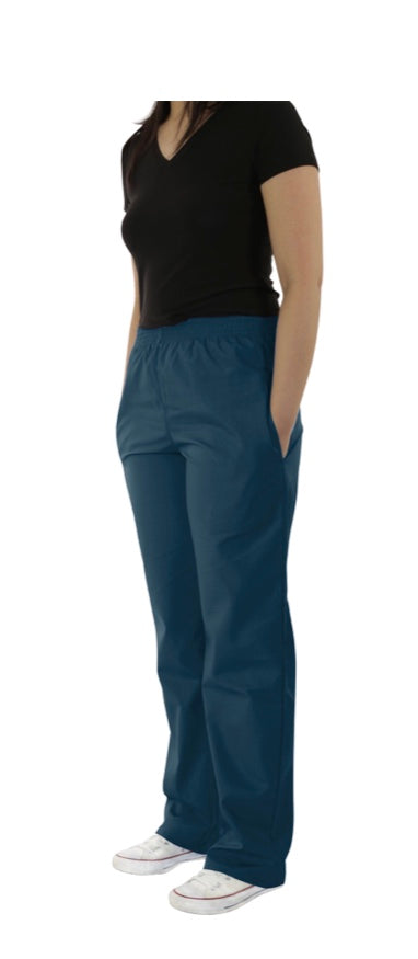 Woman standing in a black t-shirt paired with UltraSoft Unisex Classic Elastic Waist Scrub Pants 300C and white sneakers on a plain background.