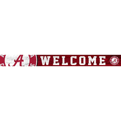 Decorative sign featuring the word "welcome" in white capital letters set on a red distress-textured background, with the logo of the university of alabama on the right.