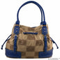 The Endall Handbag (Florida Gators) with a beige fabric featuring a repeating embossed logo pattern, accented by vibrant blue leather trim and handles.