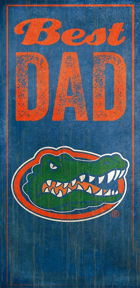 A University of Florida Best Dad Sign featuring the words "best dad" in orange text above the logo of a green alligator in an oval, all set against a blue distressed background.