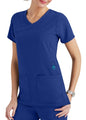 Woman wearing a blue scrub top with v-neck and two front pockets, accentuated with a teal id tag holder.
