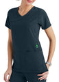 A woman wearing a dark gray medical scrub top with multiple pockets, featuring a stylish v-neck and green accents.