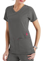 A woman wearing a gray nursing scrubs top with pockets, featuring red accents and a v-neck design.