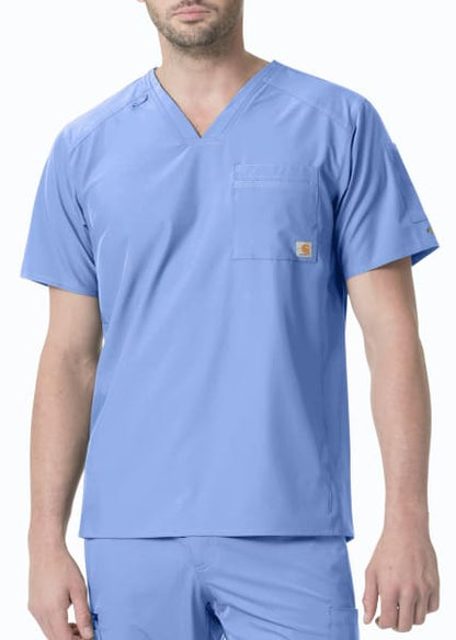 A man in light blue medical scrubs with a Slim Fit V-Neck Top (Mens Liberty C15106) featuring a chest pocket, standing against a plain background.