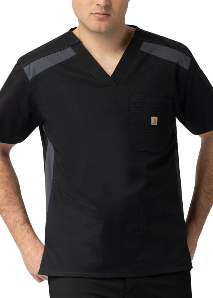 A man wearing a V-Neck Color Block Top (Men's C15418) with mesh panels on the shoulders and a chest pocket featuring a logo patch.