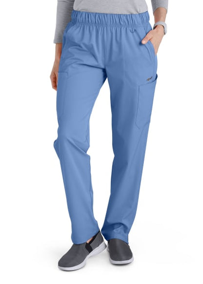 Woman wearing Comfort Waist Utility Cargo Pants (Women's C53106) and grey sneakers, standing with one hand in pocket, white background.