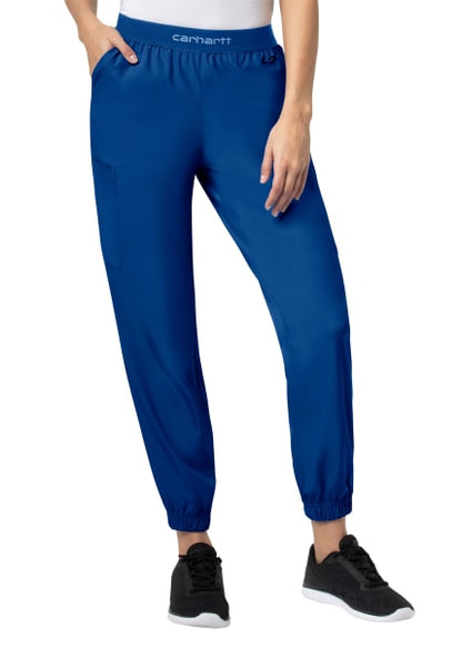 A person wearing Carhartt Liberty Comfort Cargo Jogger Scrub Pants (Women's C54106) and black sneakers, focusing on the mid-section and legs.