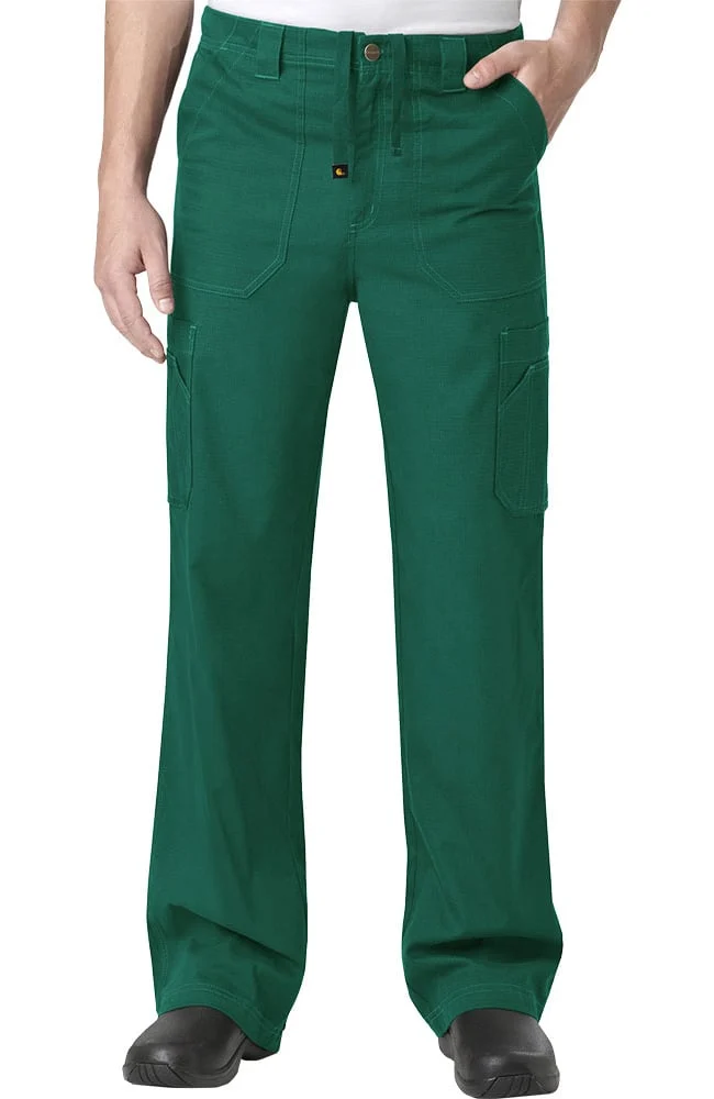 A person wearing green cargo pants with side pockets, standing with hands partially in pockets, on a plain background.