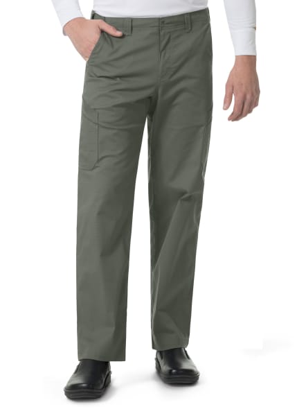 Man wearing Carhartt Ripstop Rugged Flex Straight Leg Cargo Pants (Men's C56418) and black shoes, standing with one hand partially inserted into a pocket.