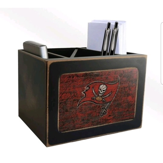 A Tampa Bay Buccaneers Team Color Desktop Organizer with a pirate flag design, containing pens and a stack of note papers, against a white background.